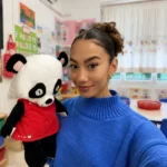 Jenzia posing with a panda puppet in her Spanish primary school classroom for a blog post on the honest reality of teaching English in Spain.